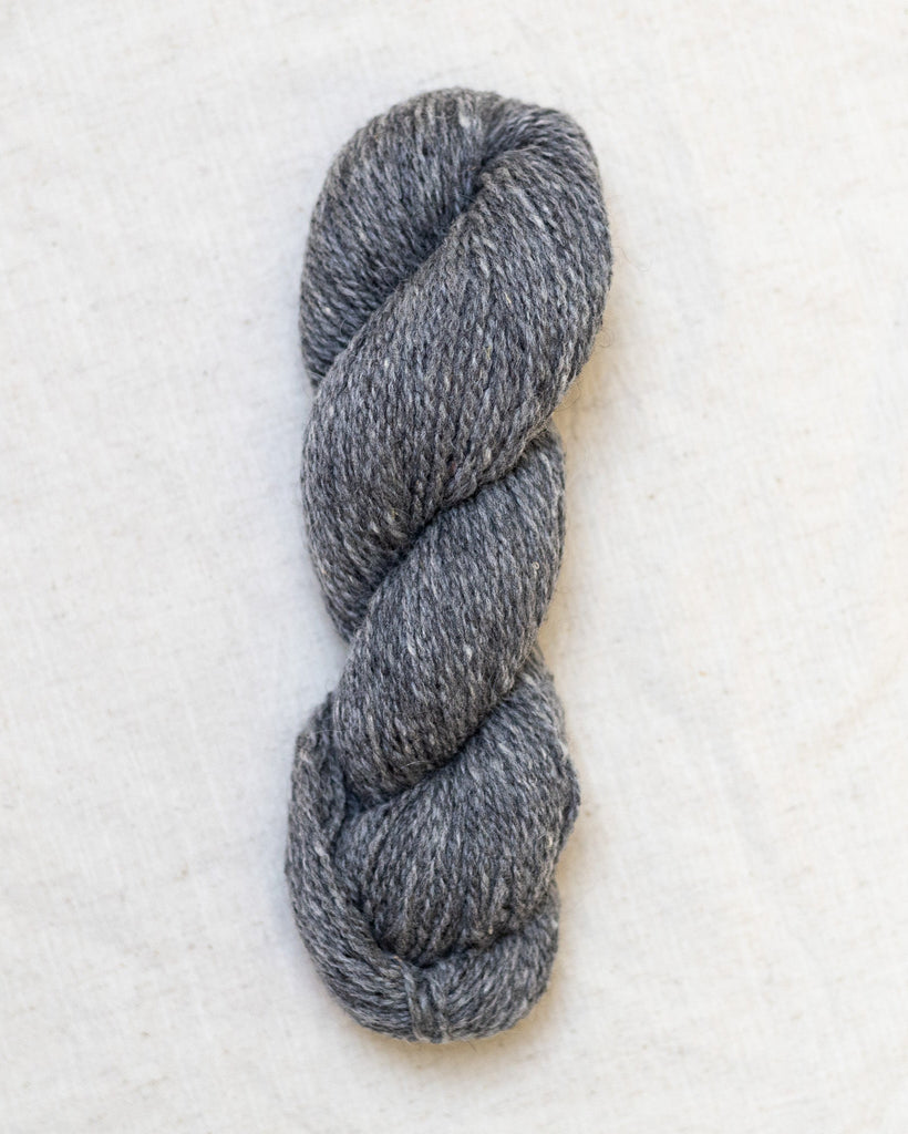 medium gray skein of yarn on a white background