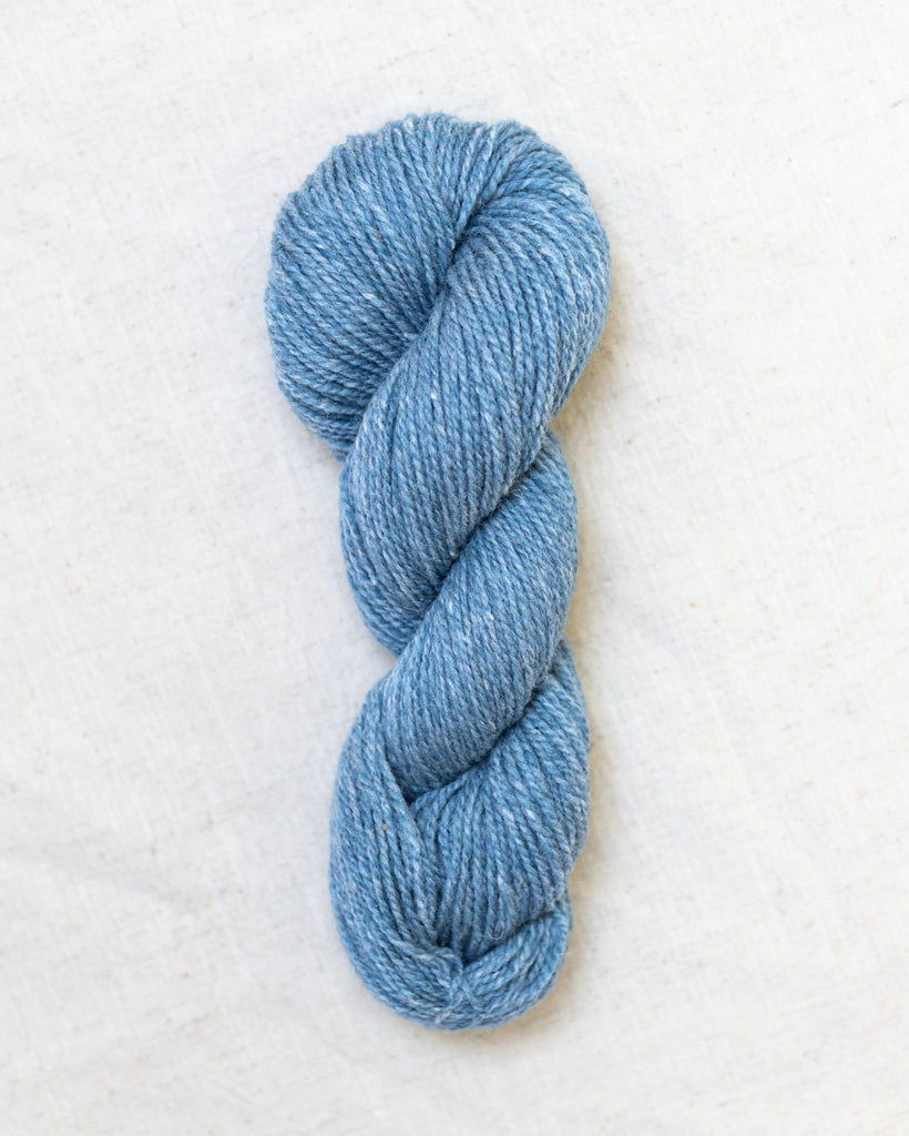 Light blue skein of yarn on a white background